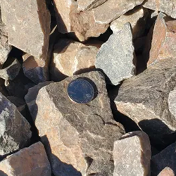 A pile of Amaretto 2 - 4 inch gravel, commonly used for driveways, landscaping and pathways, providing a durable and low-maintenance surface.